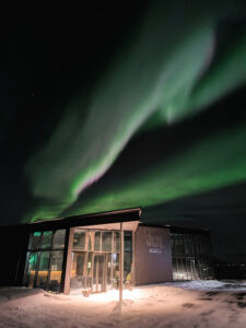 Northern lights above the restaurant building at Ringstad Resort at night