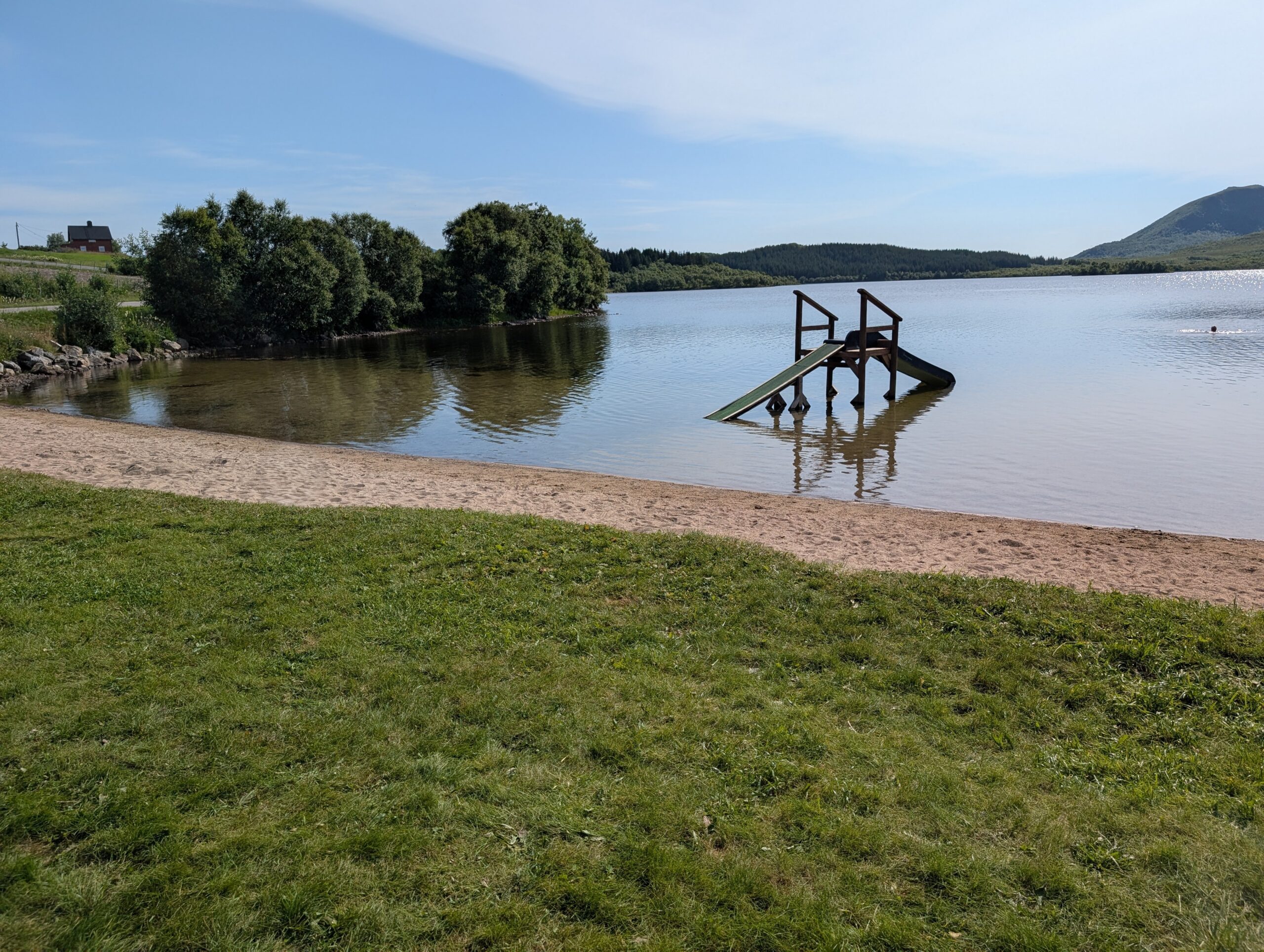 Lakeside swimming area near Ringstad Resort on a summer day