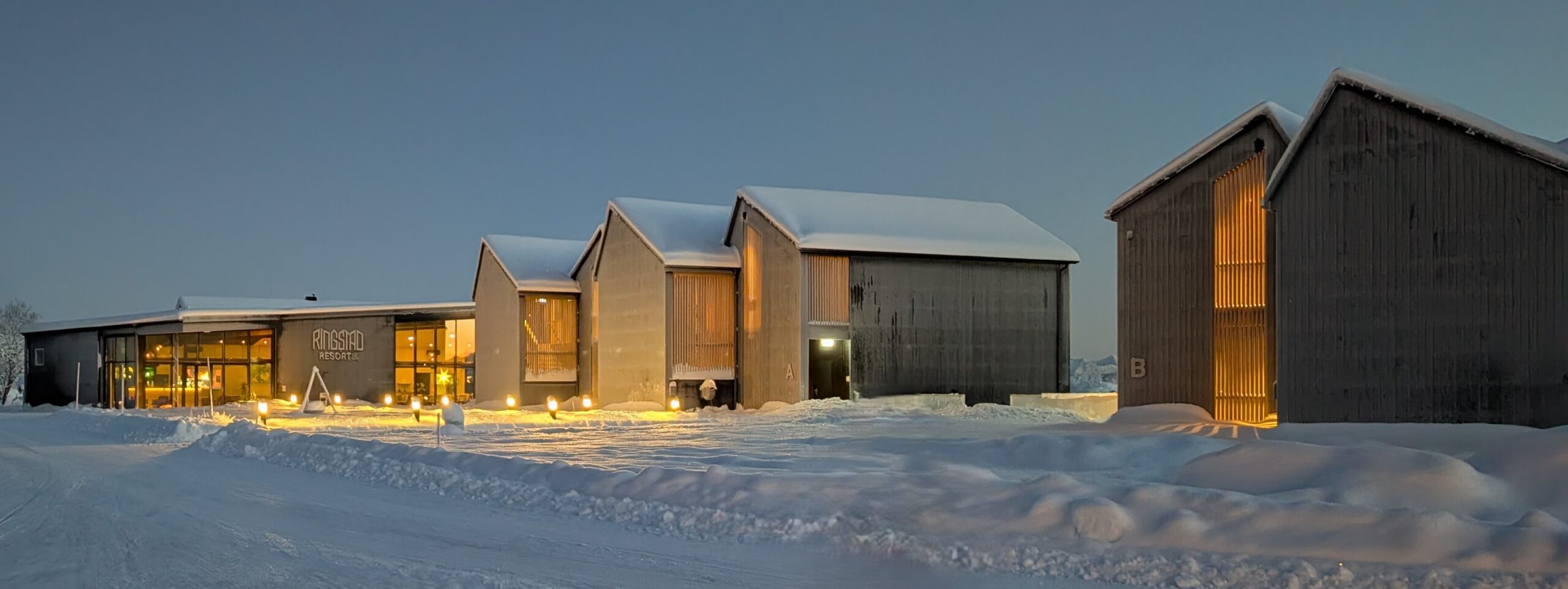 Ringstad Resort buildings lit up on a snowy winter evening