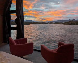 Sunset over the sea viewed through large windows at Ringstad Resort