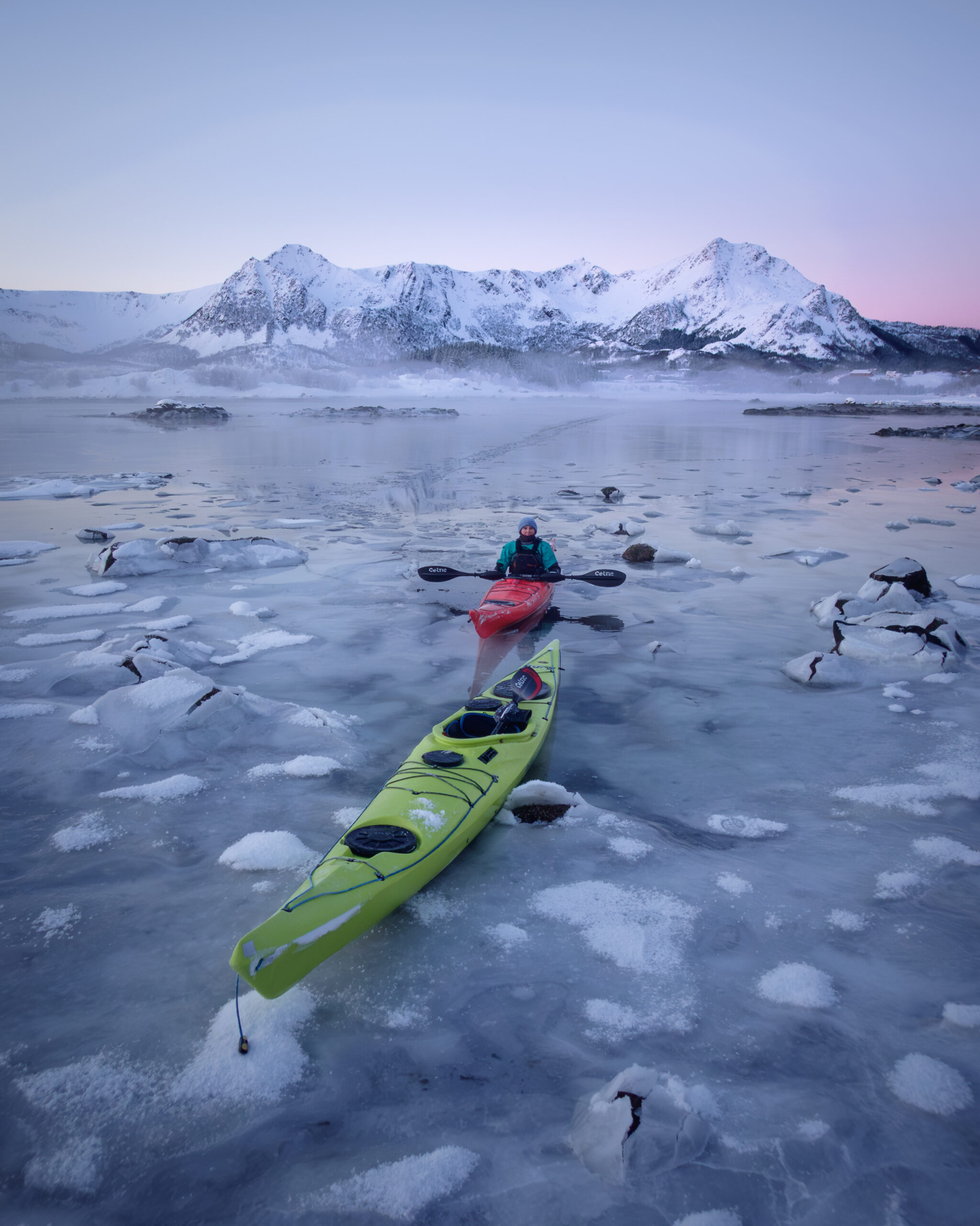 Guests kayaking among ice floes during a winter kayaking experience at Ringstad Resort