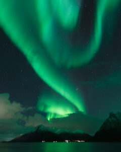 Northern lights over mountains and sea in Arctic Norway